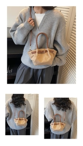 Detail view of retro canvas mini bucket bag with dark brown leather trim and shoulder strap