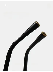 Macro detail of ergonomic curved black and gold eyewear temples for enhanced comfort