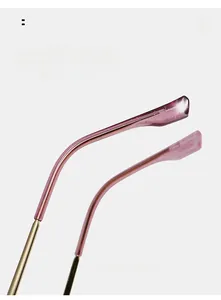 Detail of pink cat-eye glasses with curved metal legs and glitter resin temple tips