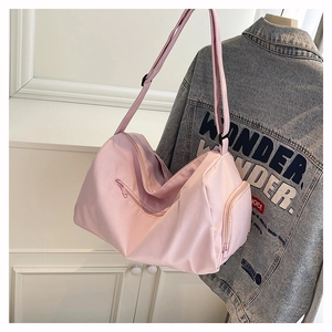 Close-up of a pink waterproof travel bag showing side zipper pocket for shoe storage