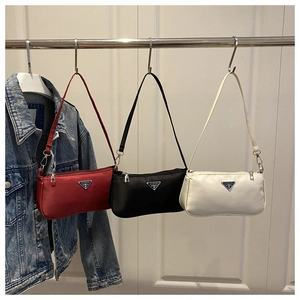 Three elegant nylon shoulder bags in red, black, and white with metal triangle logos
