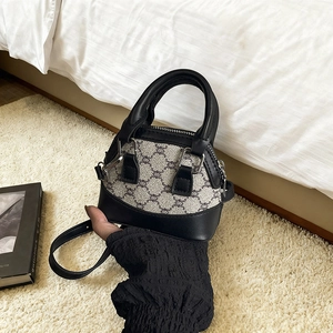 Mini shell-shaped crossbody bag for girls with dark grey pattern and black leather handles