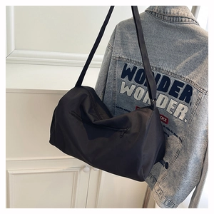 Detail of black nylon pillow bag showing zipper pocket and durable smooth fabric