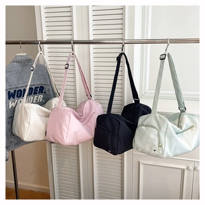 Detailed view of large travel tote bags in four colors with adjustable shoulder straps