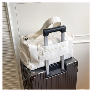 Close-up of travel bag with luggage sleeve and hidden zip pocket on silver suitcase