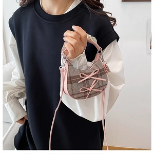 Detailed view of mini plaid crossbody bag with pink bows and lace trim decoration