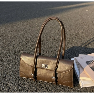 Detail of vintage dark brown baguette bag with silver twist lock and dual slim straps