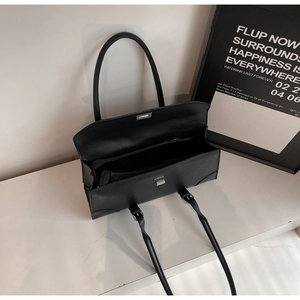 Top view of black rectangular shoulder bag showing interior space and silver square buckle