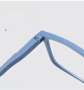 Macro detail of the durable metal spring hinge on light blue ultra-light reading glasses