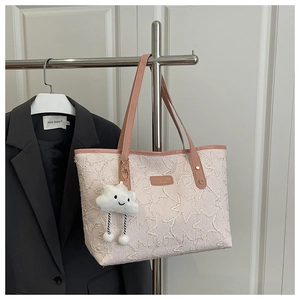 Pink quilted tote bag with star embroidery, leather straps and a plush cloud charm