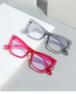 Close-up of stylish cat-eye glasses frames in pink and grey on a geometric stand