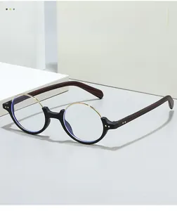 Detail of round semi-rimless glasses with matte black frames and wood-grain temples