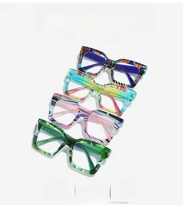 Detail of oversized anti-blue light glasses in four artistic colorful patterns