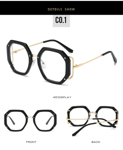 Detailansicht der achteckigen Brille mit goldenen Metallbügeln und schwarzem Rahmen