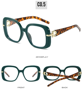 Macro detail of square sunglasses featuring green frames and tortoiseshell temples