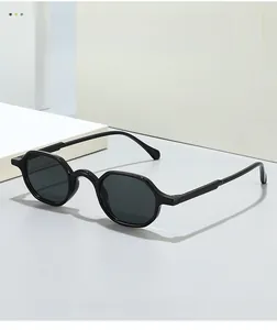 Detailed close-up of retro black hexagonal frame sunglasses with dark charcoal lenses