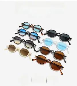 Flat lay of retro octagonal sunglasses in tortoise shell and black frames with gradient lenses
