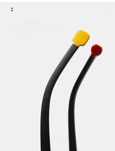 Detail of ergonomic curved glasses temples with yellow and red tips on black frames