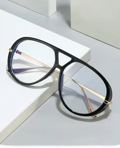 Detail of pilot glasses frame with black thick rims, gold metal temples and blue lenses
