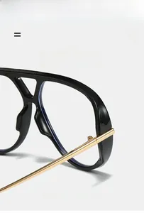 Detail of lightweight oversized sunglasses with durable metal hinges and black frame