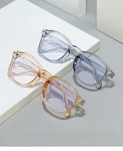 Detail of vintage square eyeglass frames with gold accents in grey and champagne colors