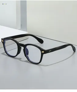 Detail of retro round glasses frame with golden wing accents and double-dot decor