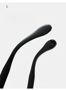Close-up of curved glossy black temples of round sunglasses for a comfortable fit