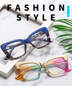 Detail view of fashionable cat-eye glasses frames with colorful contrast on marble background