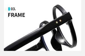 Detail of glossy black oval glasses frame featuring stylish double gold dot rivets
