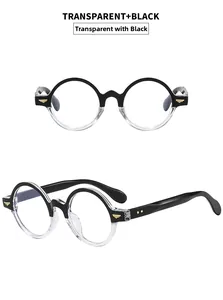 Detail view of oval retro eyewear with black and transparent two-tone frame and gold accents