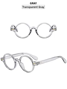 Detail view of transparent grey retro round frames with golden wing metal hardware