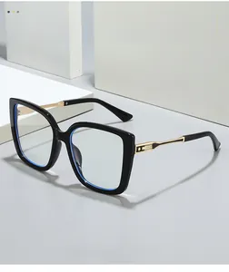 Detail of black cat-eye glasses frame with gold textured hinge and star accents
