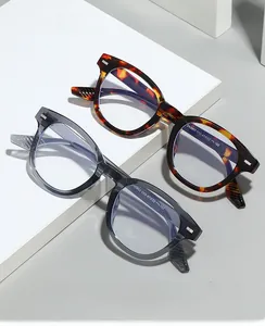 Macro detail of tortoiseshell and smoke gray glasses on geometric white pedestals