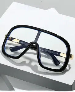 Detailed view of oversized black square frames with golden metal temples and model text