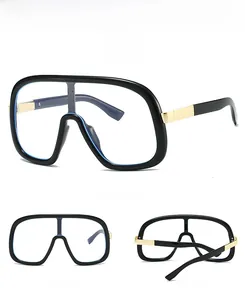 Detail view of large flat top glasses with glossy black frame and gold metal temples