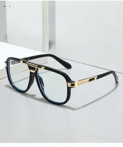 Detail of oversized black and gold glasses frame with metal accents and sleek temple design