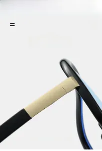 Detail of glossy black glasses frame with golden metal hinge and super elastic material