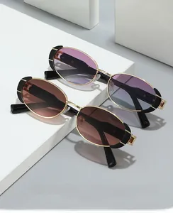 Detail of vintage oval metal sunglasses with purple gradient lenses and gold temples