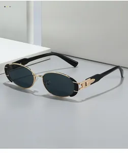 Detailed macro view of vintage oval sunglasses with gold metal frame and black accents
