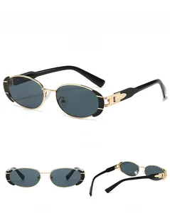 Detailed views of vintage oval sunglasses with black and gold metal frames from multiple angles