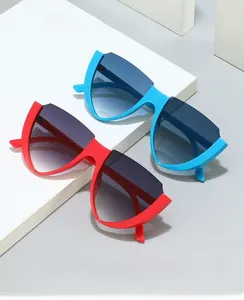 Detail of V-shaped rimless cat eye sunglasses in red and blue with gradient lenses