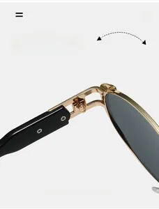 Detail of durable golden metal hinge on vintage oval sunglasses with black temples