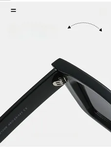 Macro shot of silver metal hinges and size specs Z1006 engraved on black sunglasses