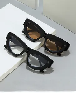 Detail of vintage cat-eye sunglasses with thick black frames on minimalist display
