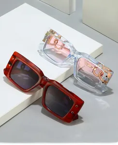 Detail of vintage thick frame sunglasses featuring gold chain accents on the temples