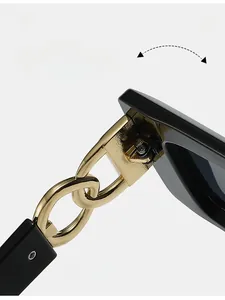 Detail of durable gold chain-link hinge design on modern black square sunglasses