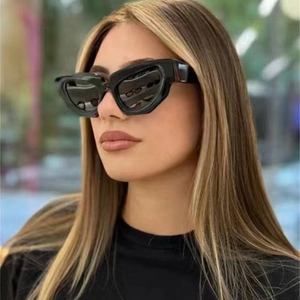 Fashionable black cat-eye sunglasses with thick geometric frames worn by a female model