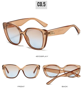 Vue détaillée de lunettes de soleil œil de chat avec monture ambre et logo doré