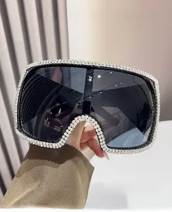 Detail of square oversized sunglasses with hand-set sparkling white rhinestones on the frame