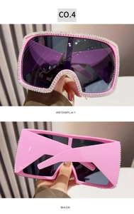 Detail view of pink oversized square sunglasses with sparkling rhinestone frame